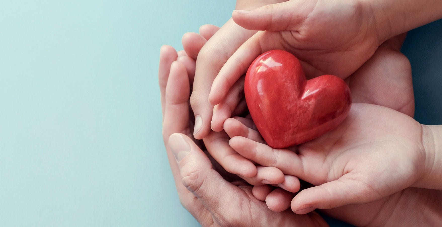 adult and child hands holding red heart on aqua background, heart health, donation, CSR concept, world heart day, world health day, family day