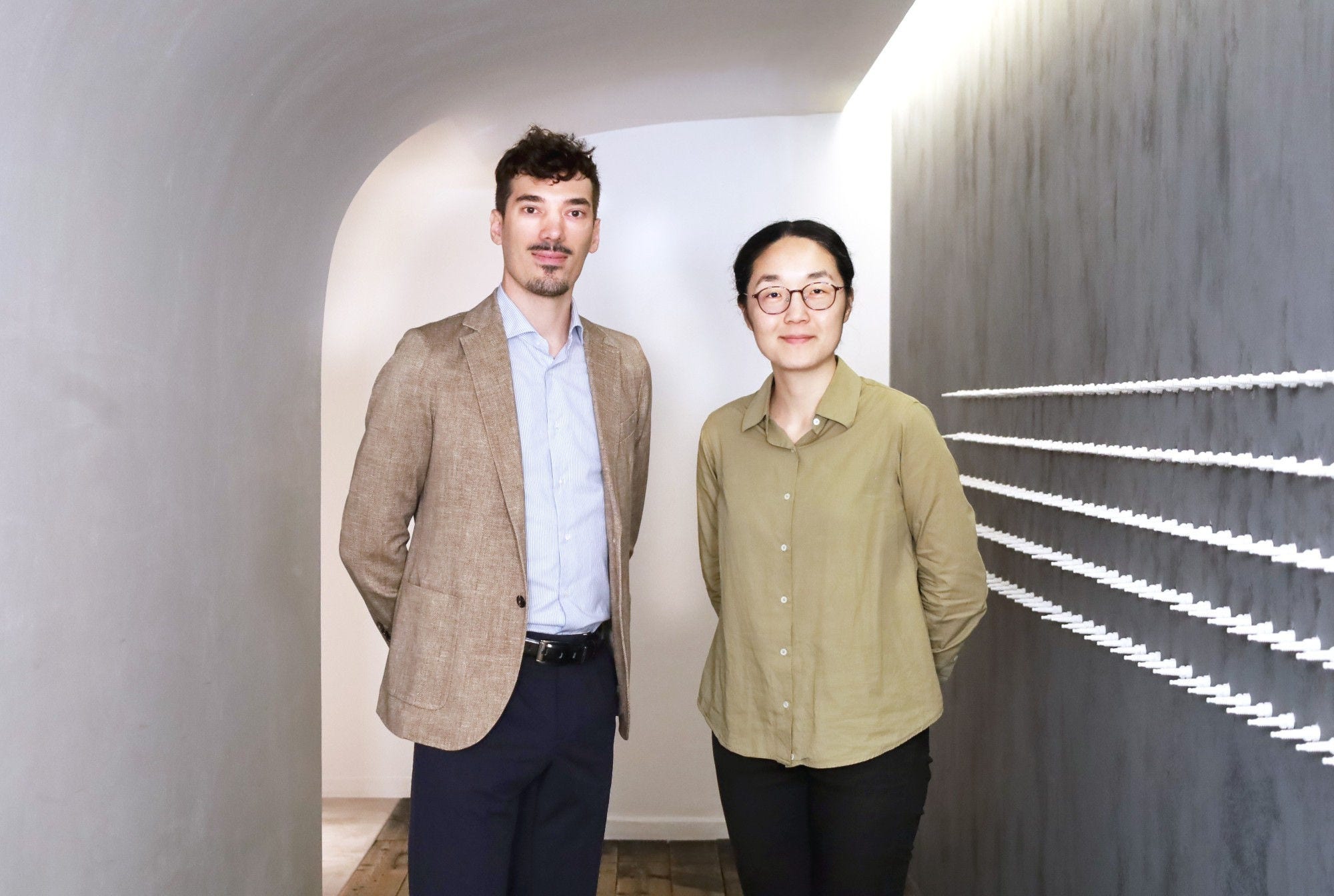 2 people are standing in a hallway