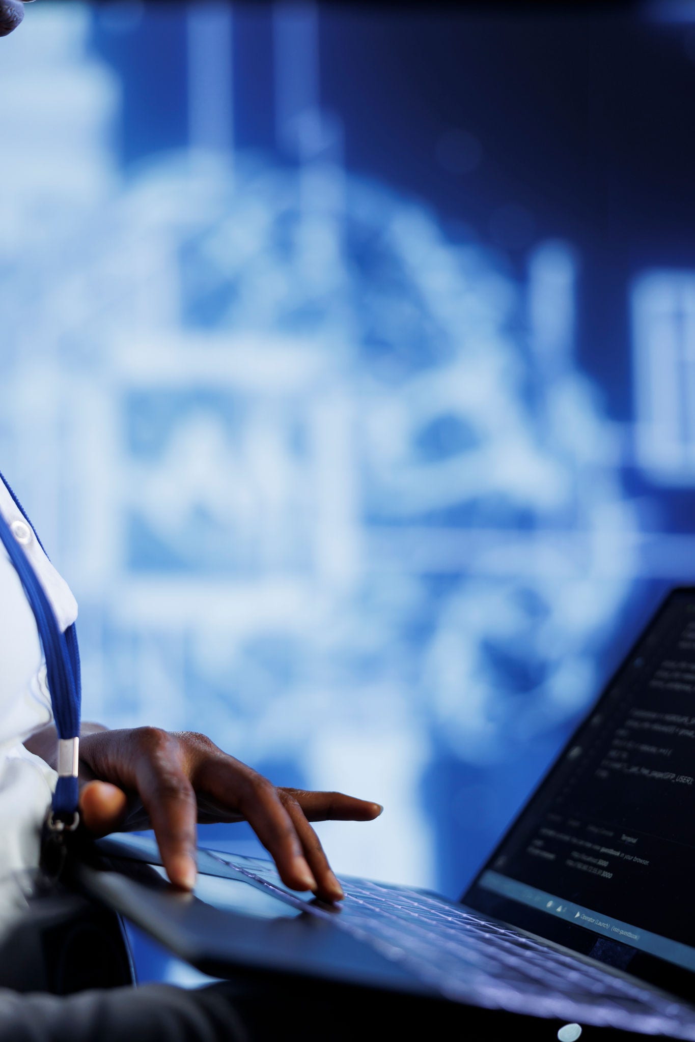 System administrator writes code on laptop to visualize artificial intelligence neural networks using augmented reality, close up. High tech facility worker runs AI script for information processing