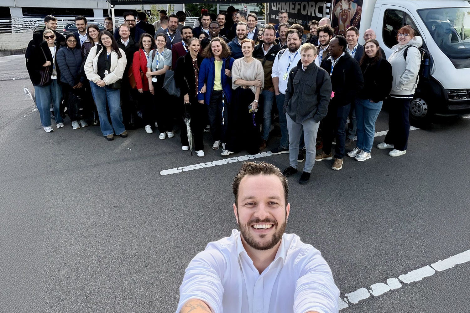 A selfie of a group of people with a food truck in the background.