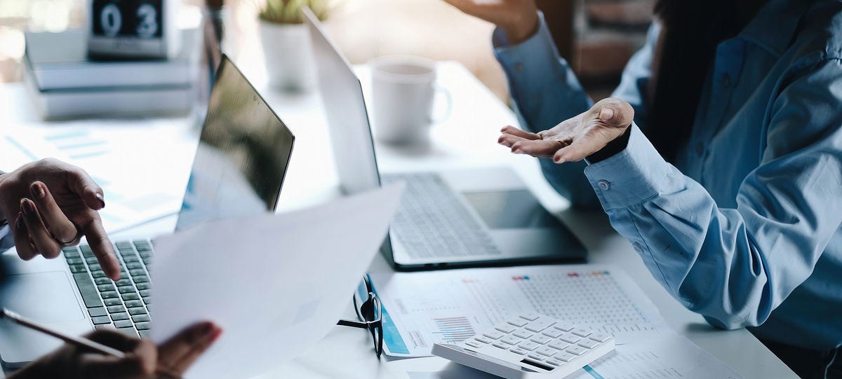 Two leader business women discussing the charts and graphs showing the results Two leader business women discussing the charts and graphs showing the results.