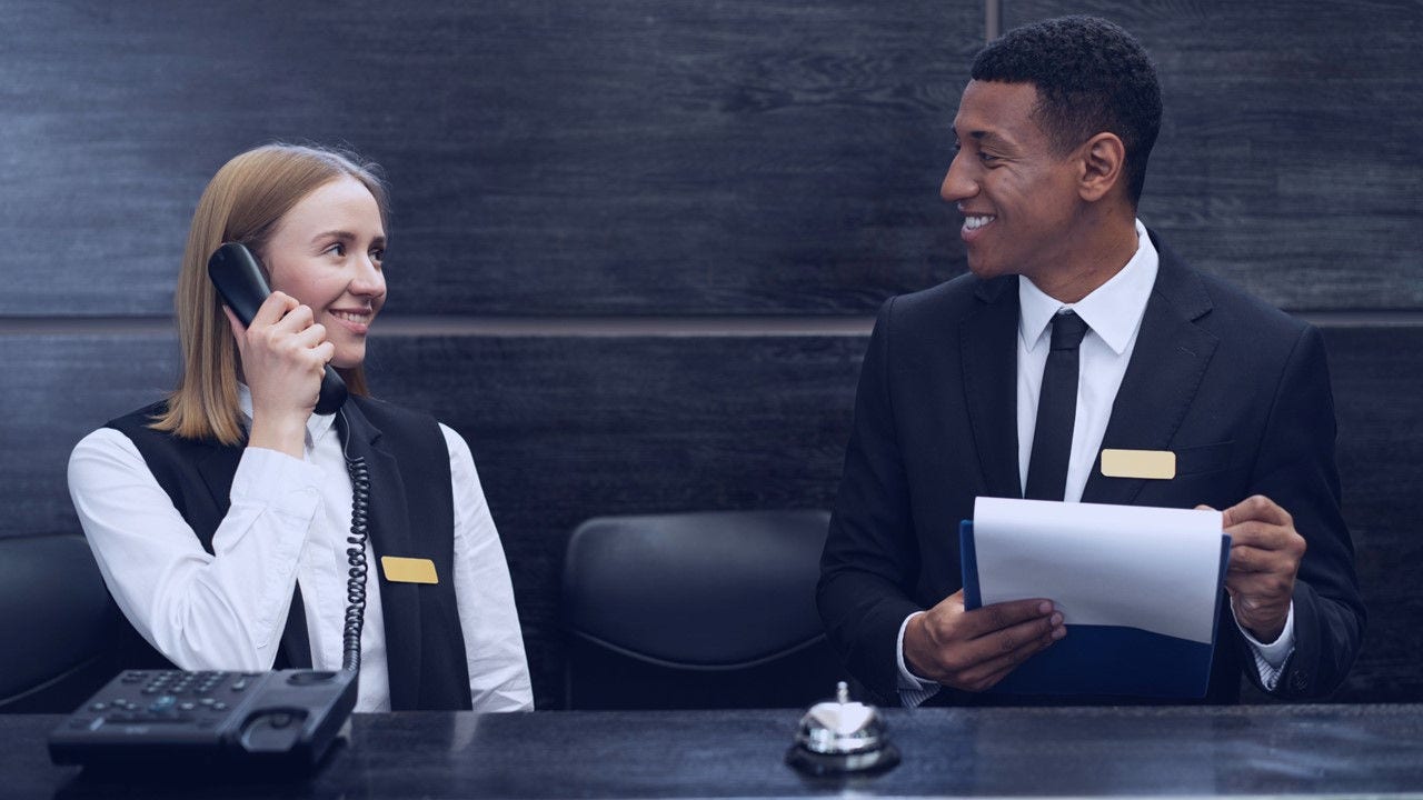 Persons working at hotel reception.