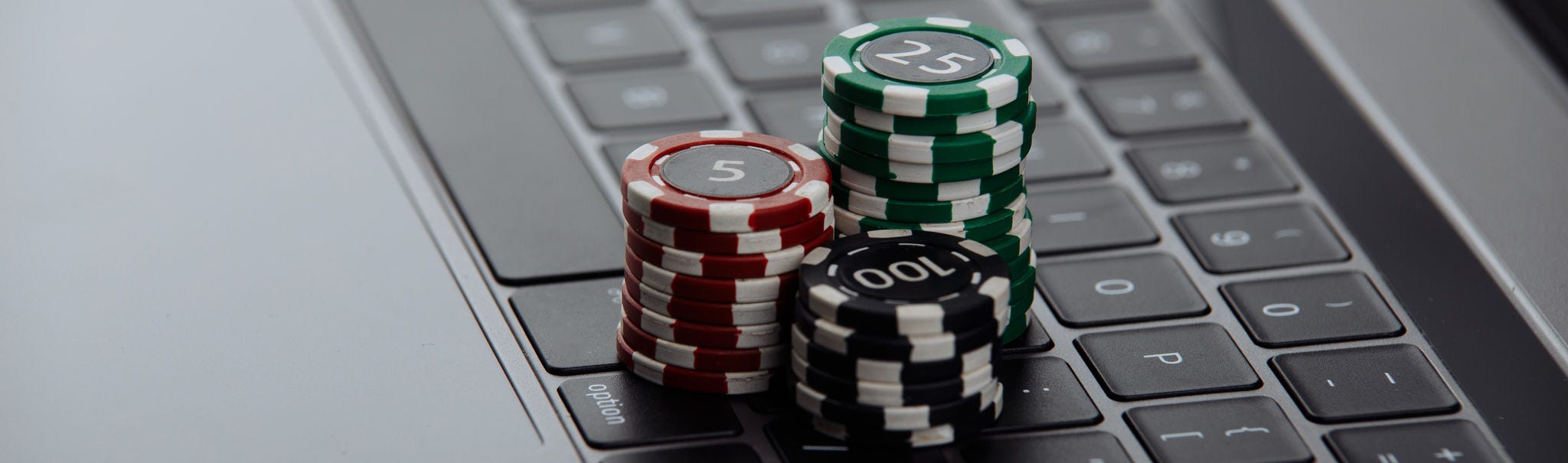 Poker chips on laptop. Casino online concept., Poker chips on laptop. Casino online concept.