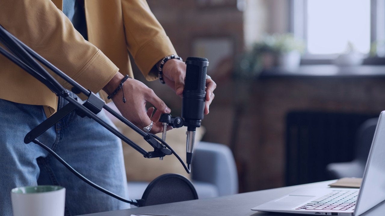 Person recording an audio with a mic.