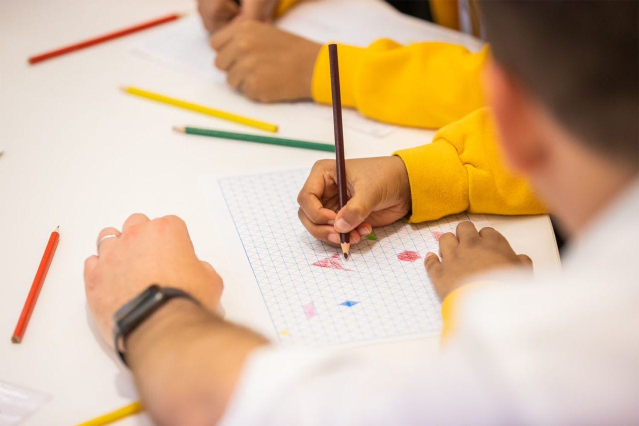 Children completing a colouring exercise