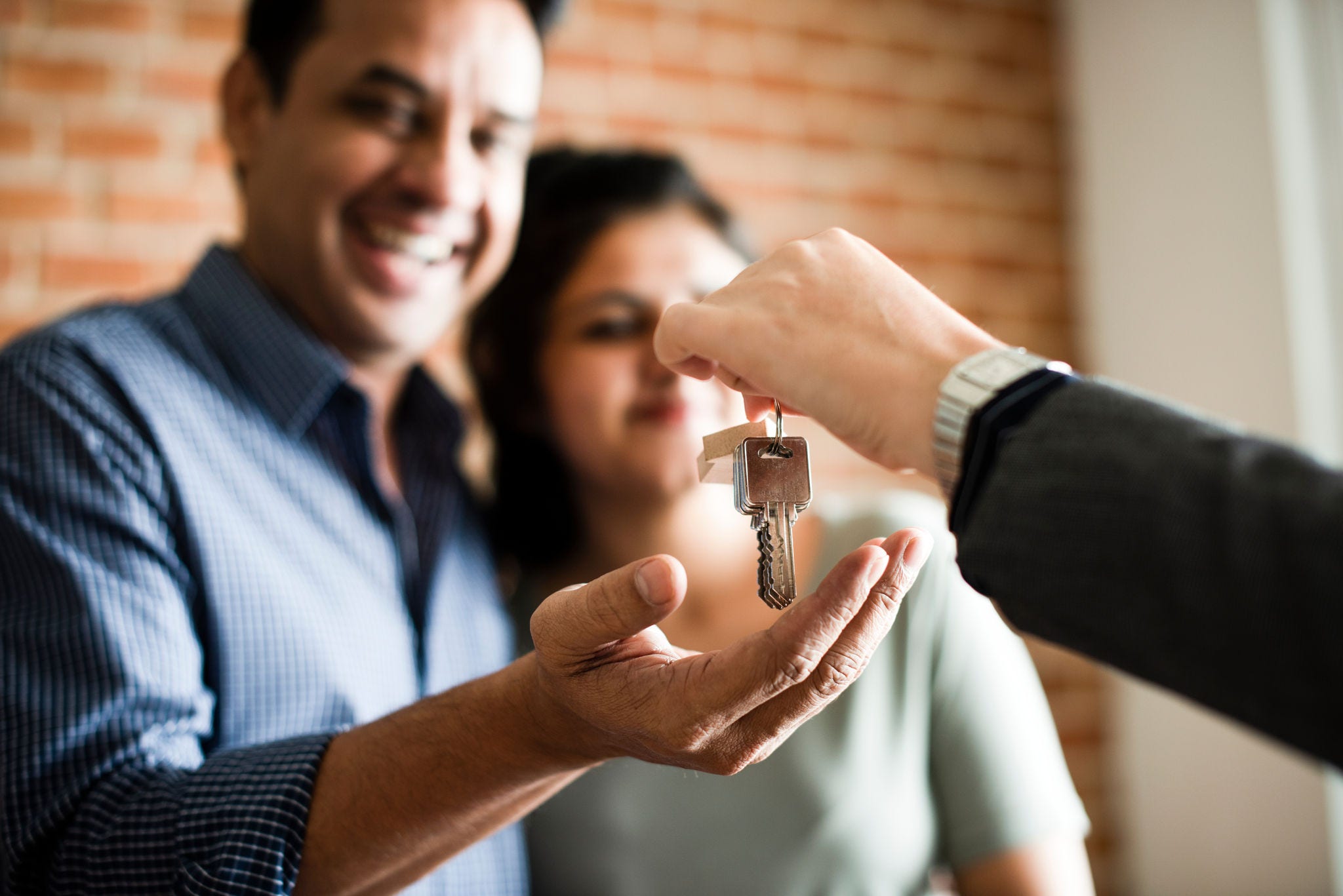 Cheerful couple with keys to their new home Cheerful couple with keys to their new home
