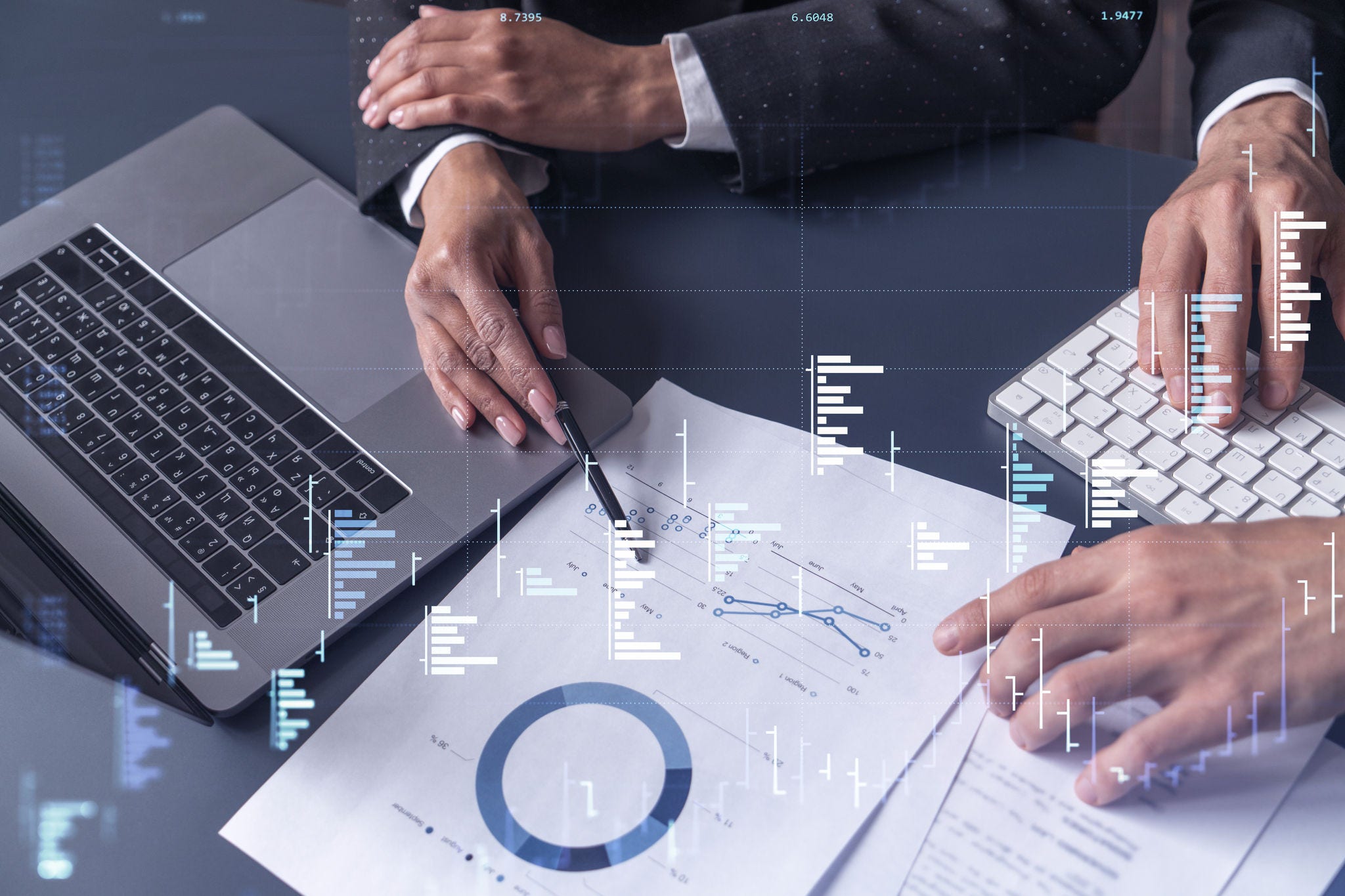 Two traders man and woman researching historic data to predict stock market behavior. Internet trading concept. Forex and financial hologram chart over the table with the documents