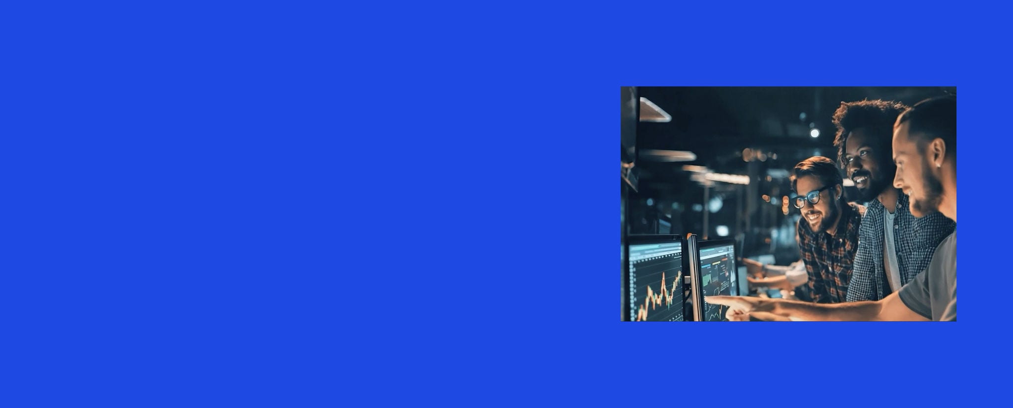 Team working together at computer monitors displaying data charts