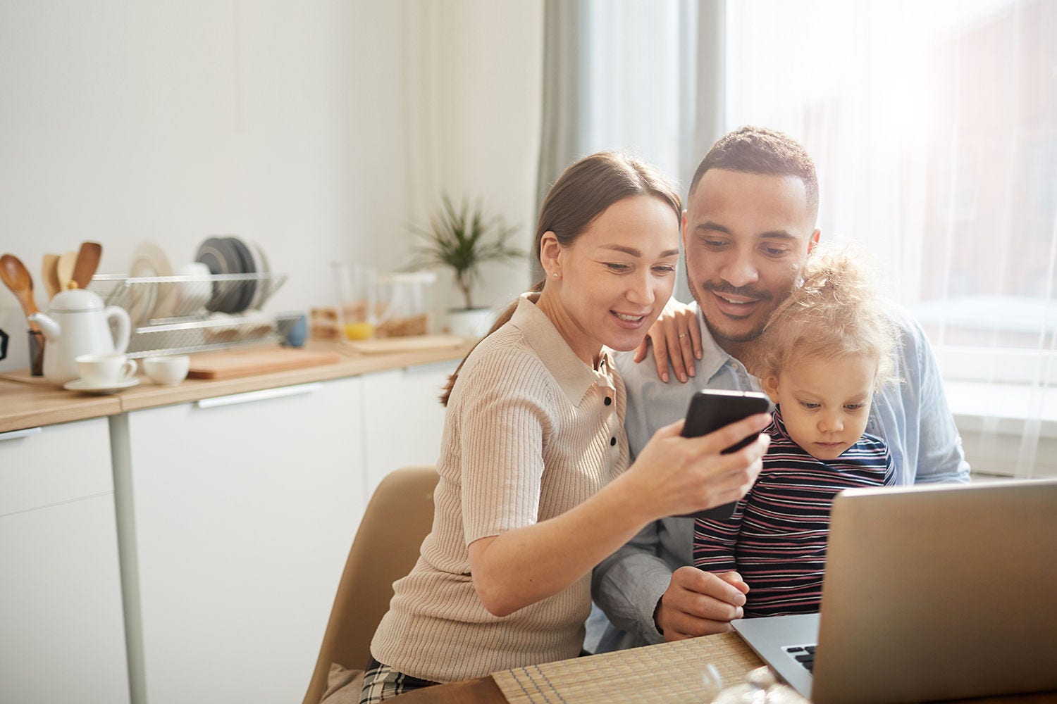 Family looking at laptop