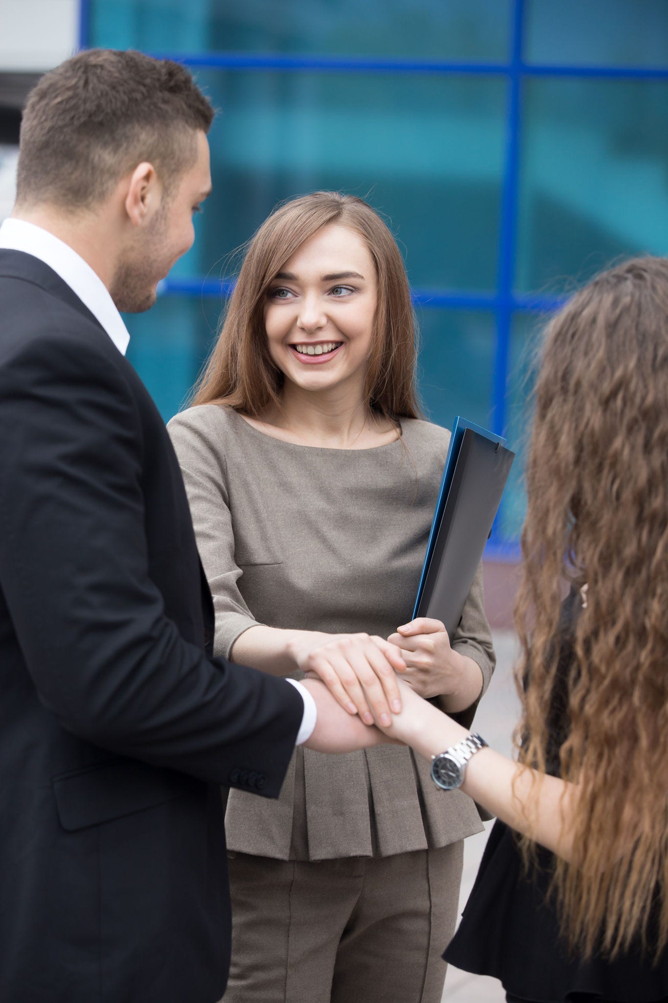 Successful happy business people joining hands working together. Focus on smiling businesswoman. Successful Deal Concept . Businesspeople Teamwork