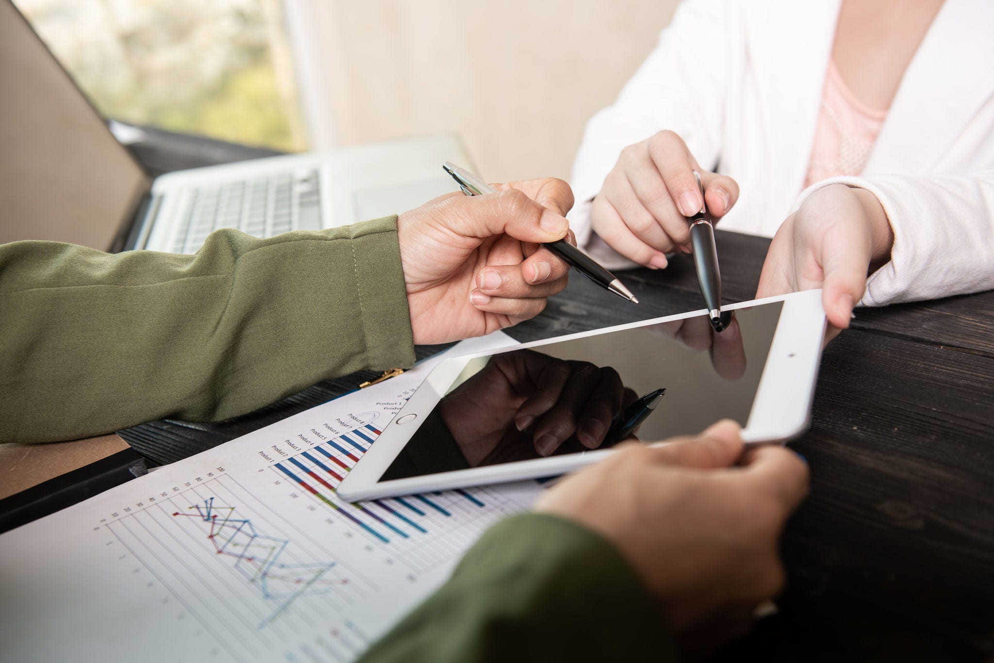 Image of two young woman business using touchpad at meeting.
business team meeting to discuss statistical data presented in the form of digital graphs and charts.