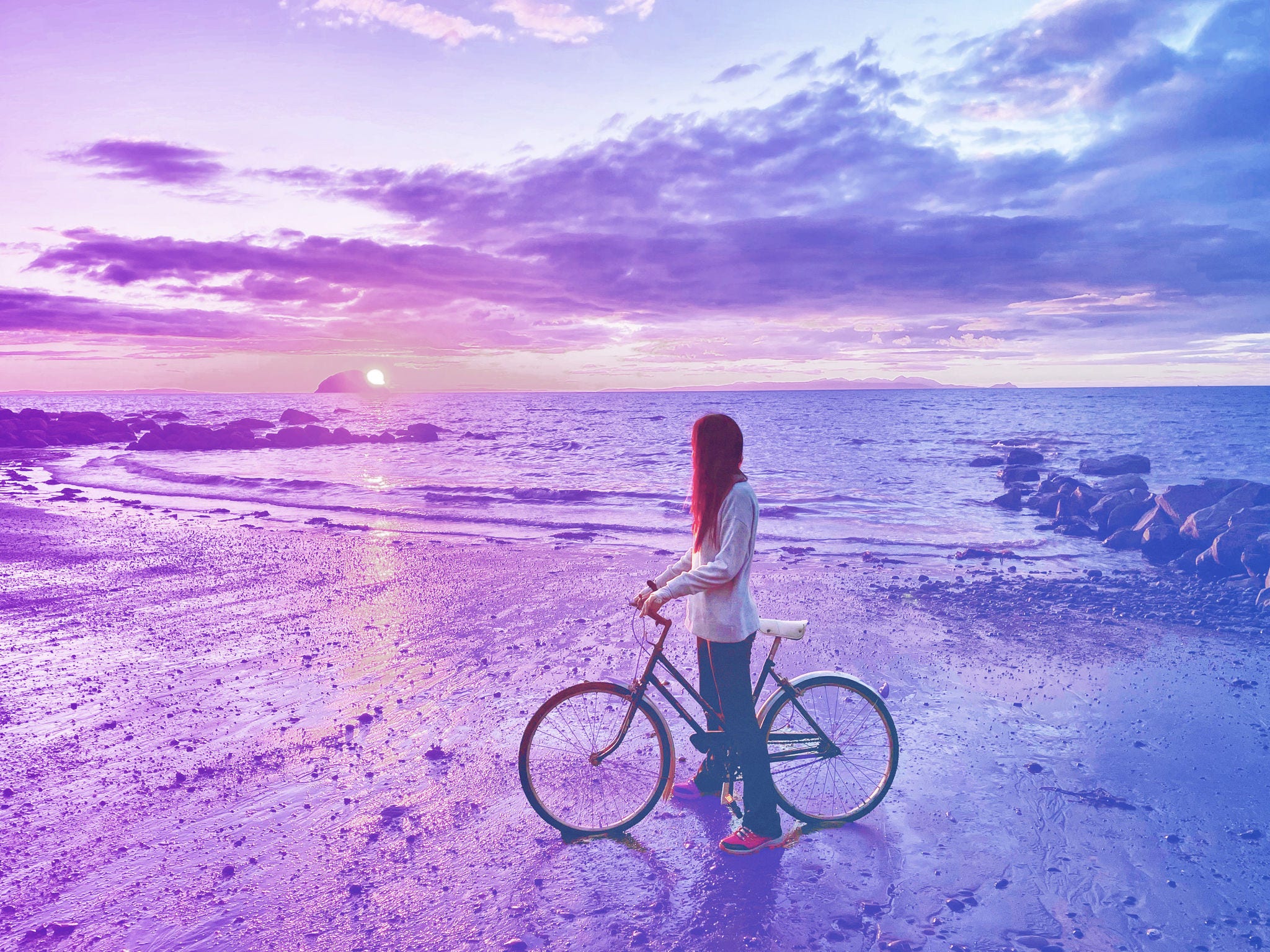 Woman On Bicycle At Beach Against Sky During Sunset