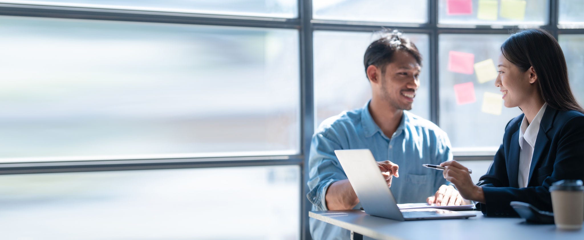 Pointing laptop, Meeting and consulting agenda of indian asia mixed race business man and female china half thai ethnicity bookkeepers discussing balance sheet, stock market profit with yearly tax.