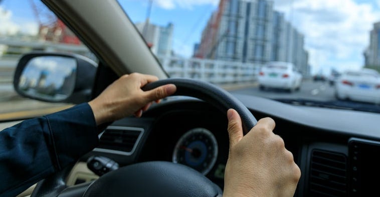 People driving car on city road