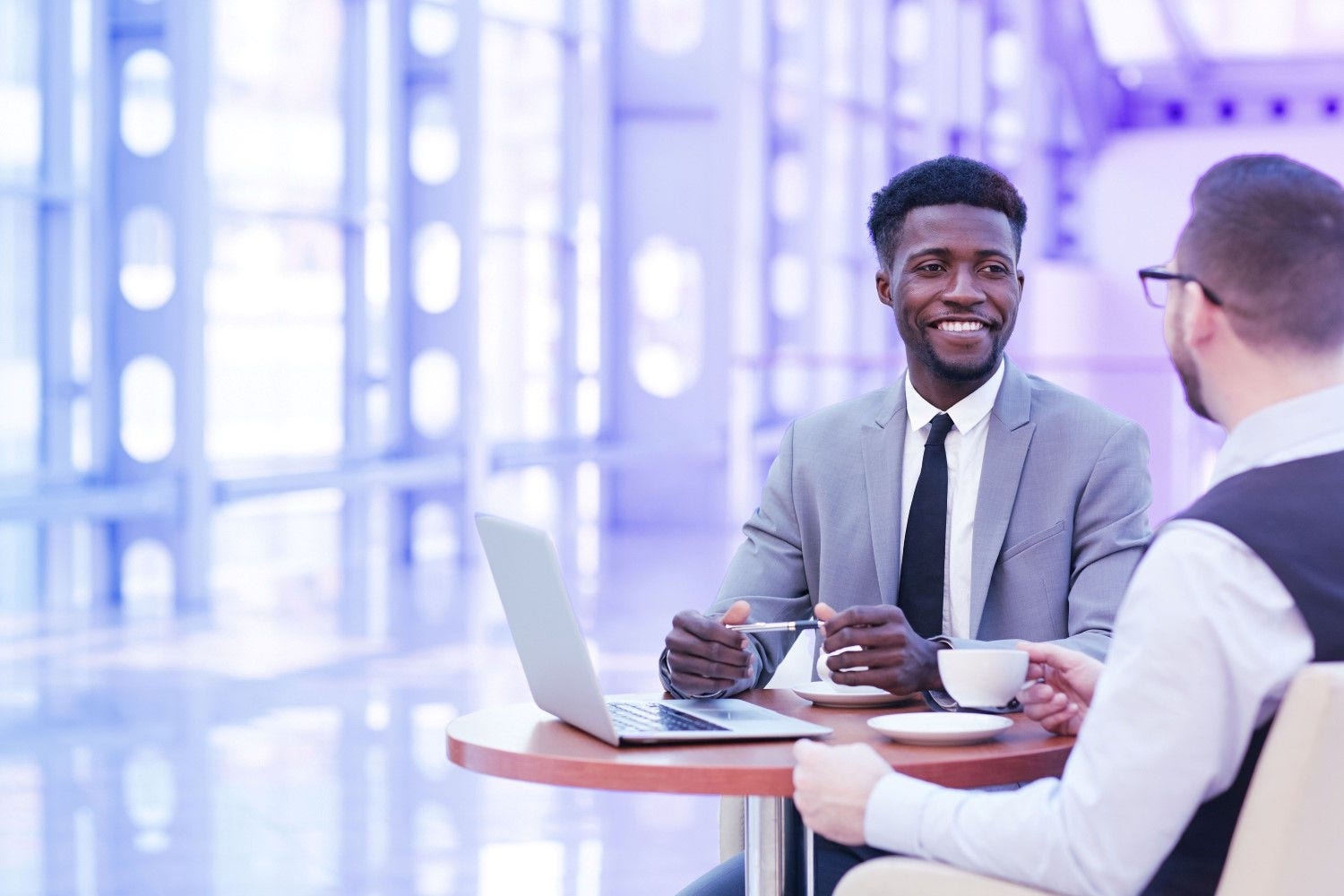 Illustration of two colleagues on a laptop