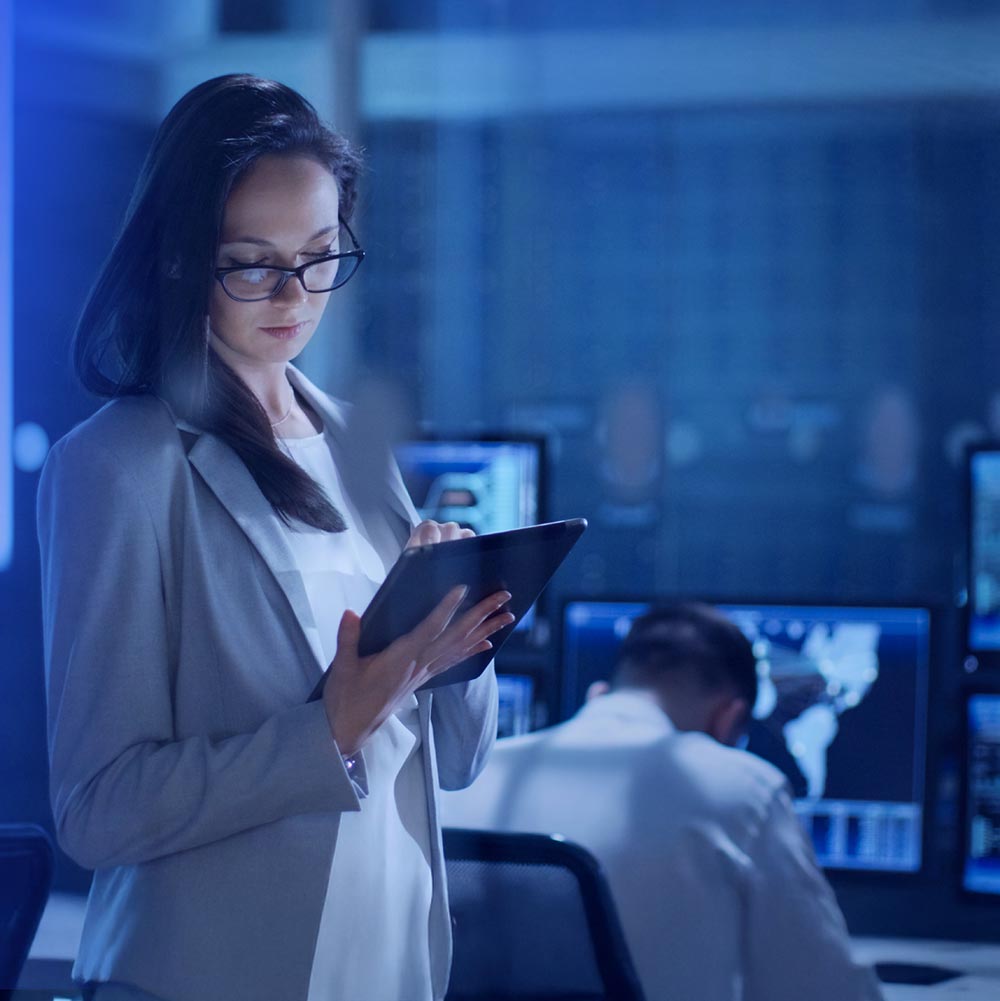 Woman using tablet in office Cyber defence strategies