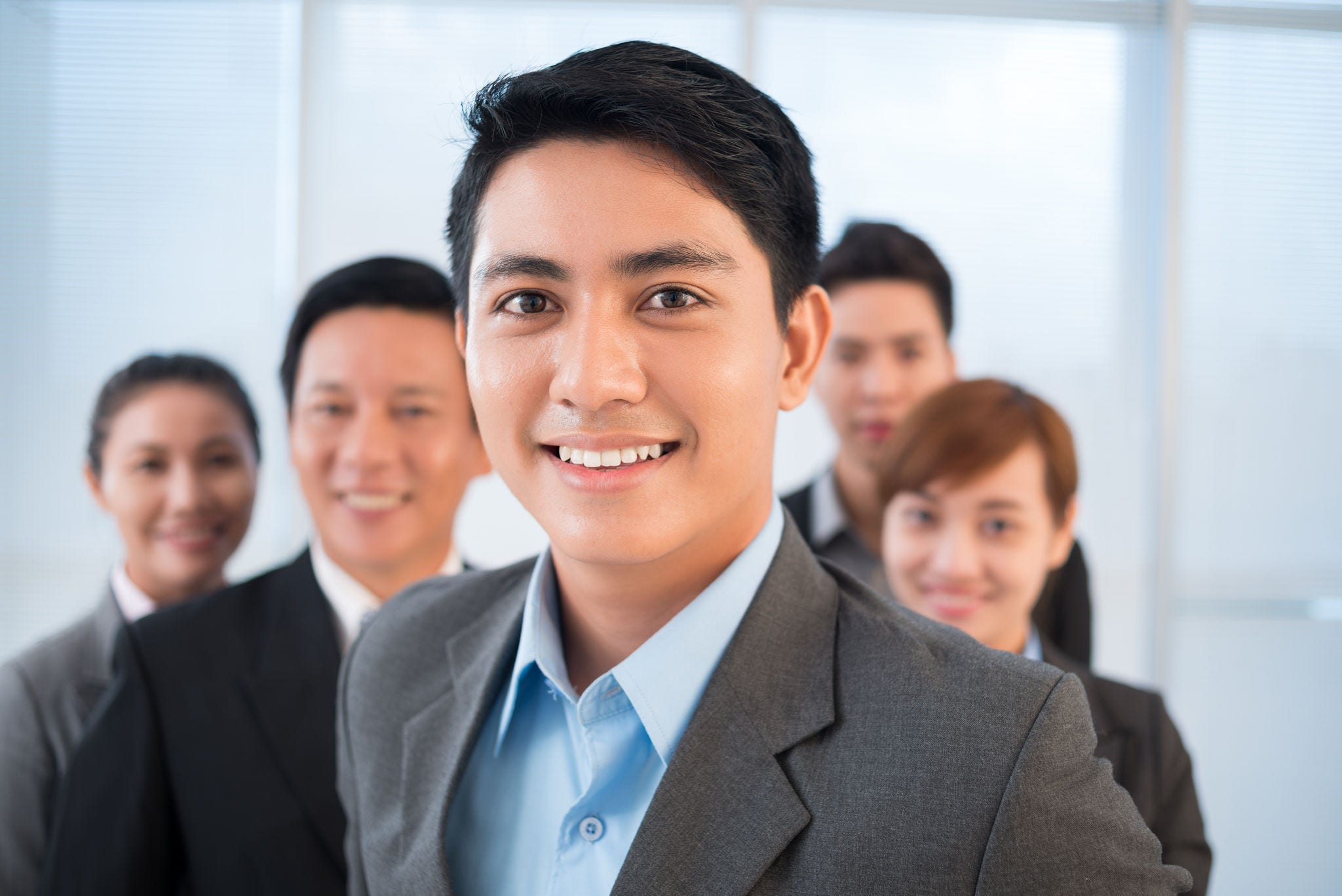 Close-up of a handsome businessman smiling and looking at camera