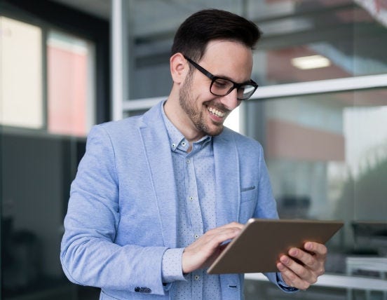 Man with spectacles with a tablet