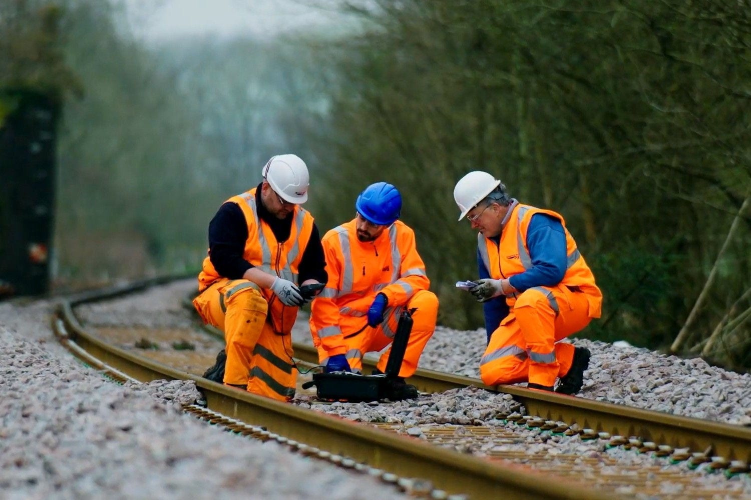 Railway workers inspecting and maintaining track infrastructure.