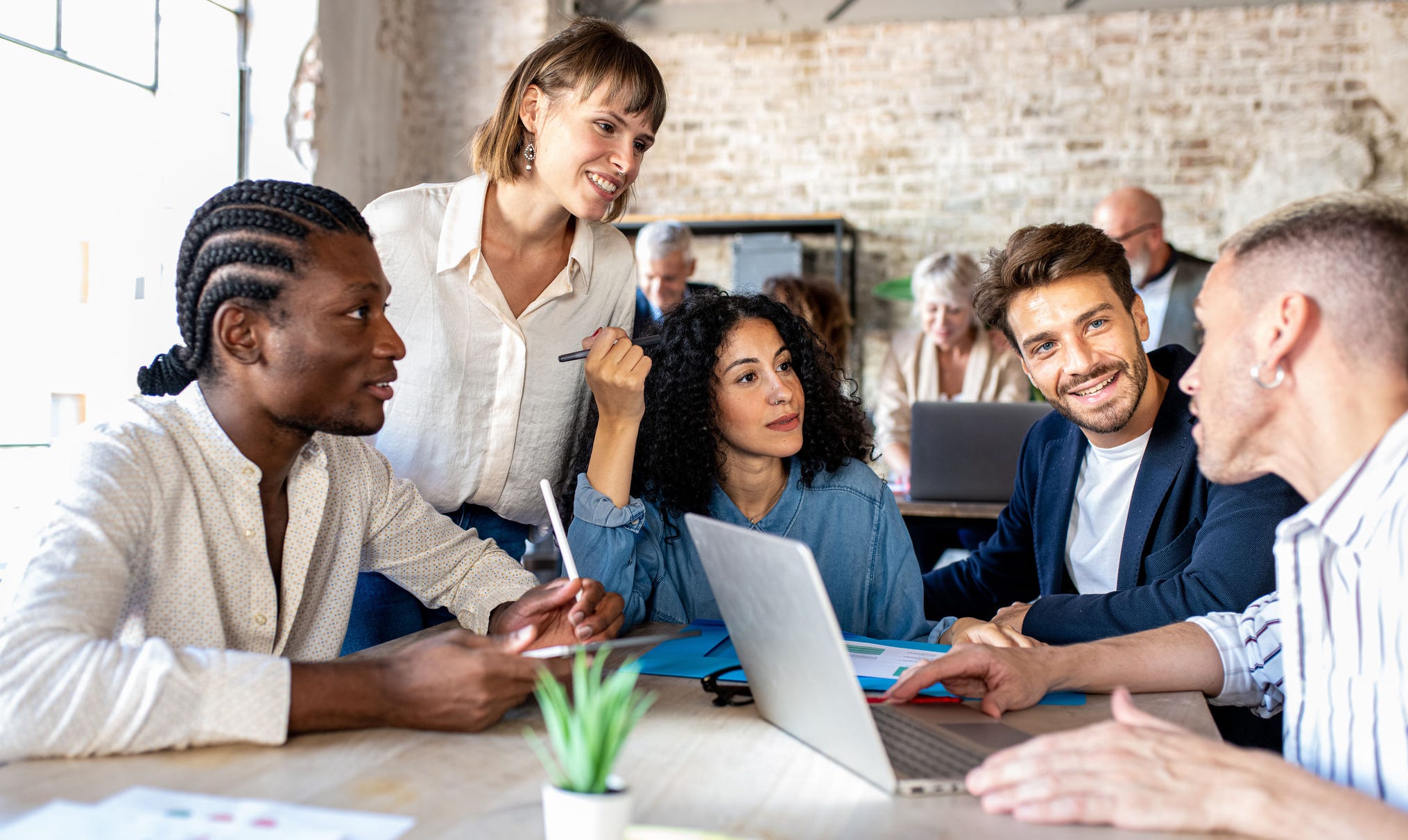 Young creative designer people working together and planning strategy, happy and successful teamwork