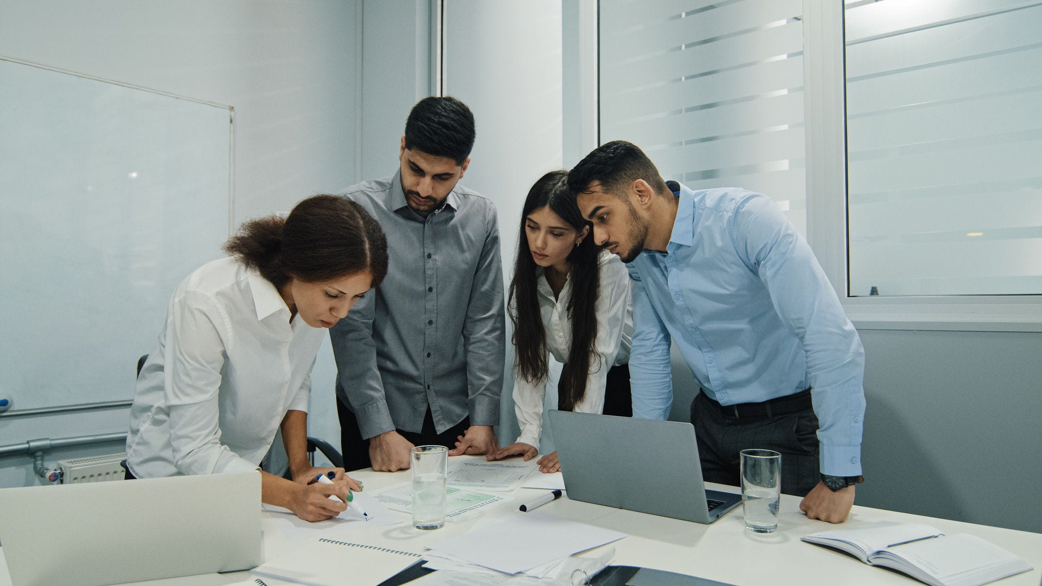 Woman team leader, successful employee mentor training diversity subordinates at corporate workshop presentation. Female business coach top manager presenting new project plan at conference office. High quality photo