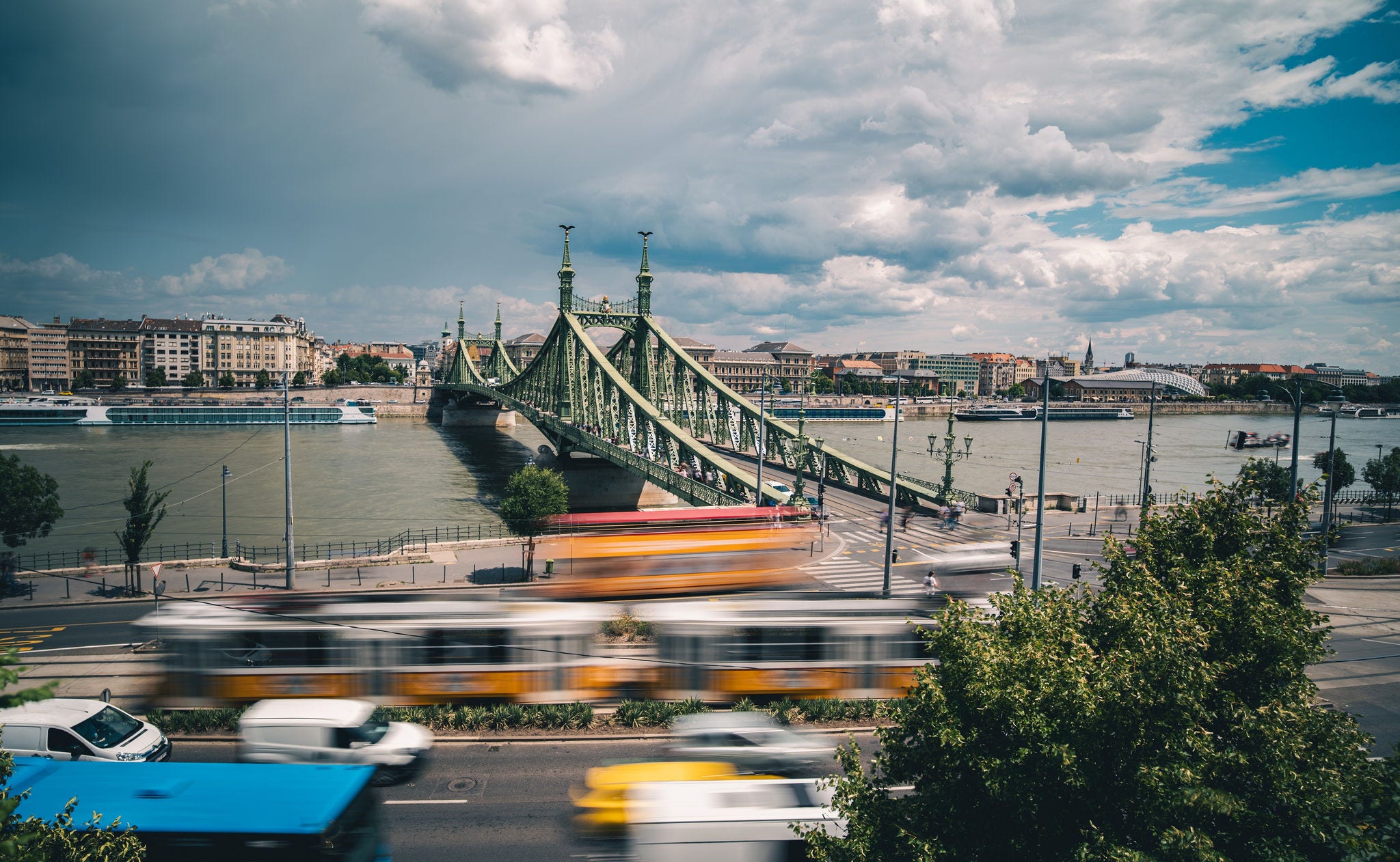 Amazing Panoramic View Of The Liberty Bridge With Heavy Traffic And The Danube River In Budapest