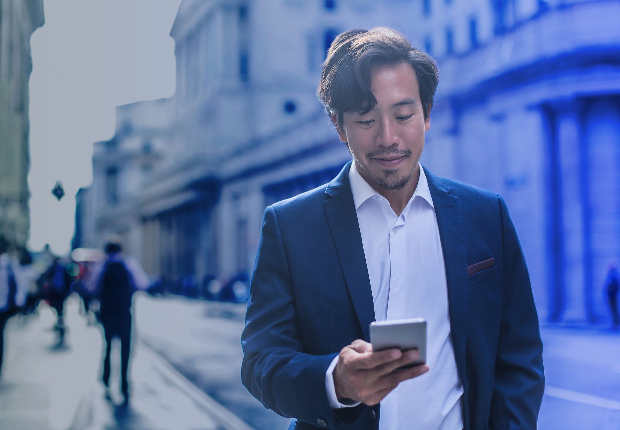 Business professional using smart phone in the city