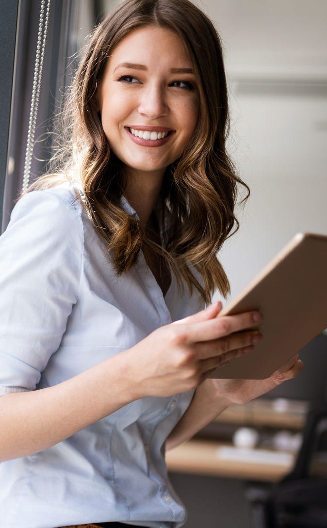 Successful young business woman looking confident and smiling