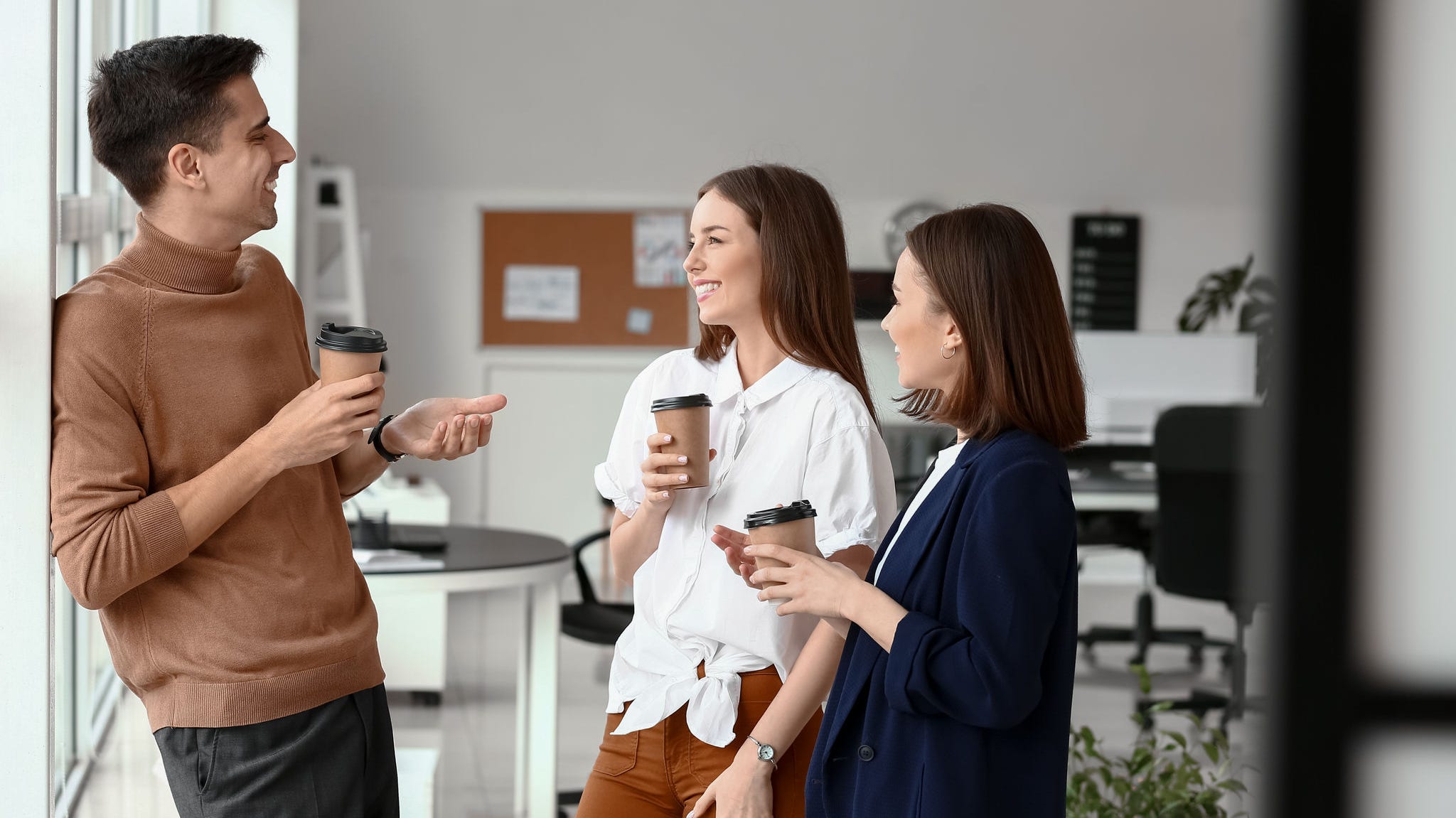 Business colleagues drinking coffee in office