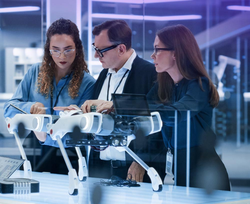 3 people working on robot 3 people working on robot