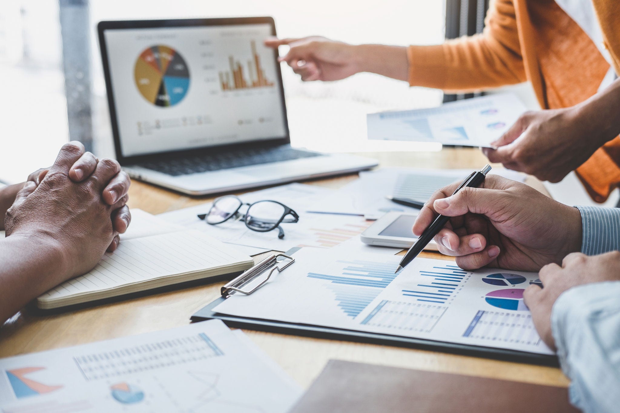 Business team collaboration discussing working analyzing with financial data and marketing growth report graph in team, presentation and brainstorming to strategy planning making profit of company.