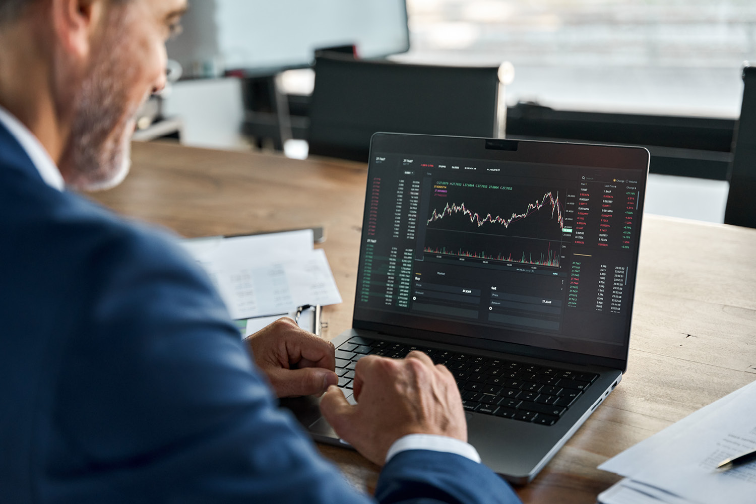 man checking stocks on laptop