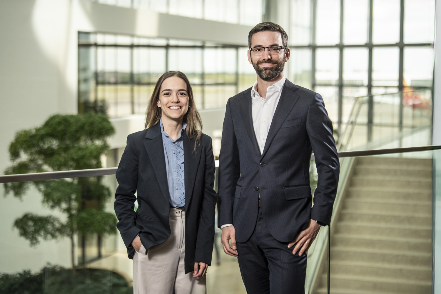 Two KPMG experts, Wim Steppé and Lorena Canterini, are looking at the camera