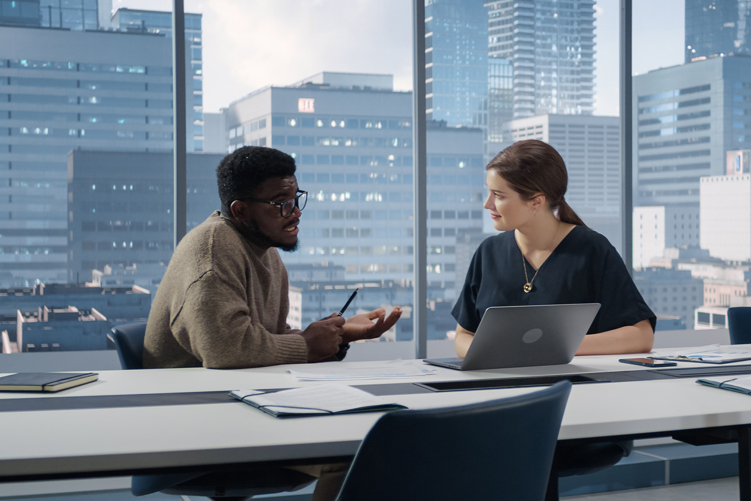 Two coworkers having discussion in office