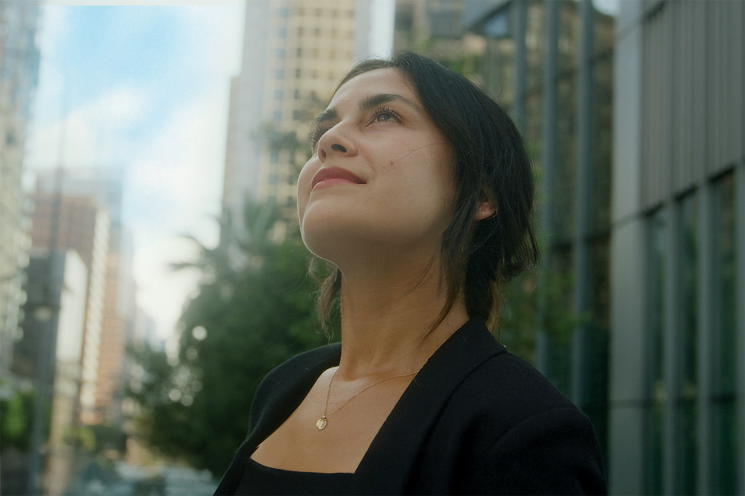 Woman looking up in a city