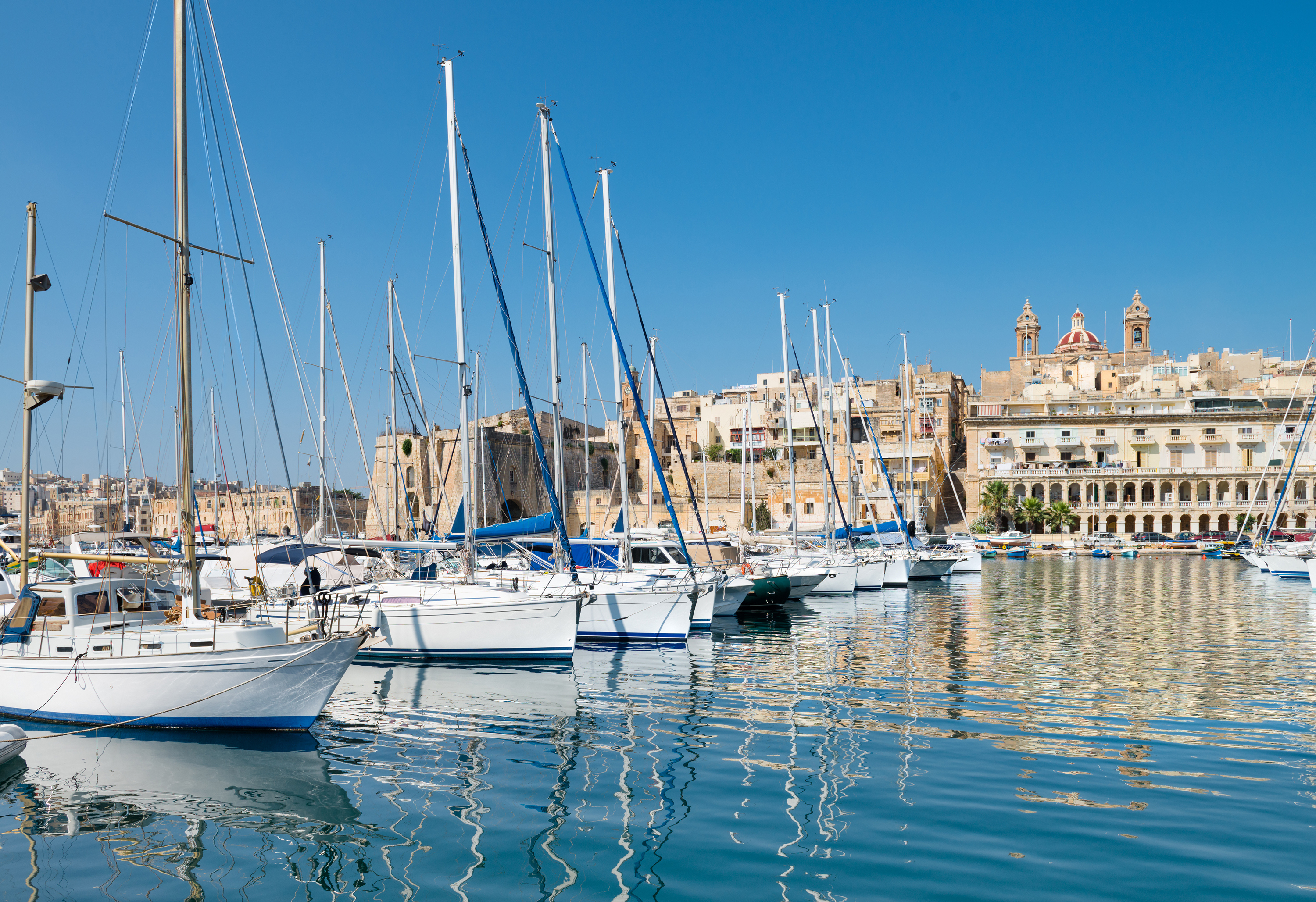 Sailing boats on Senglea marina in Grand Bay, Valetta, Malta, on a bright sunny morning