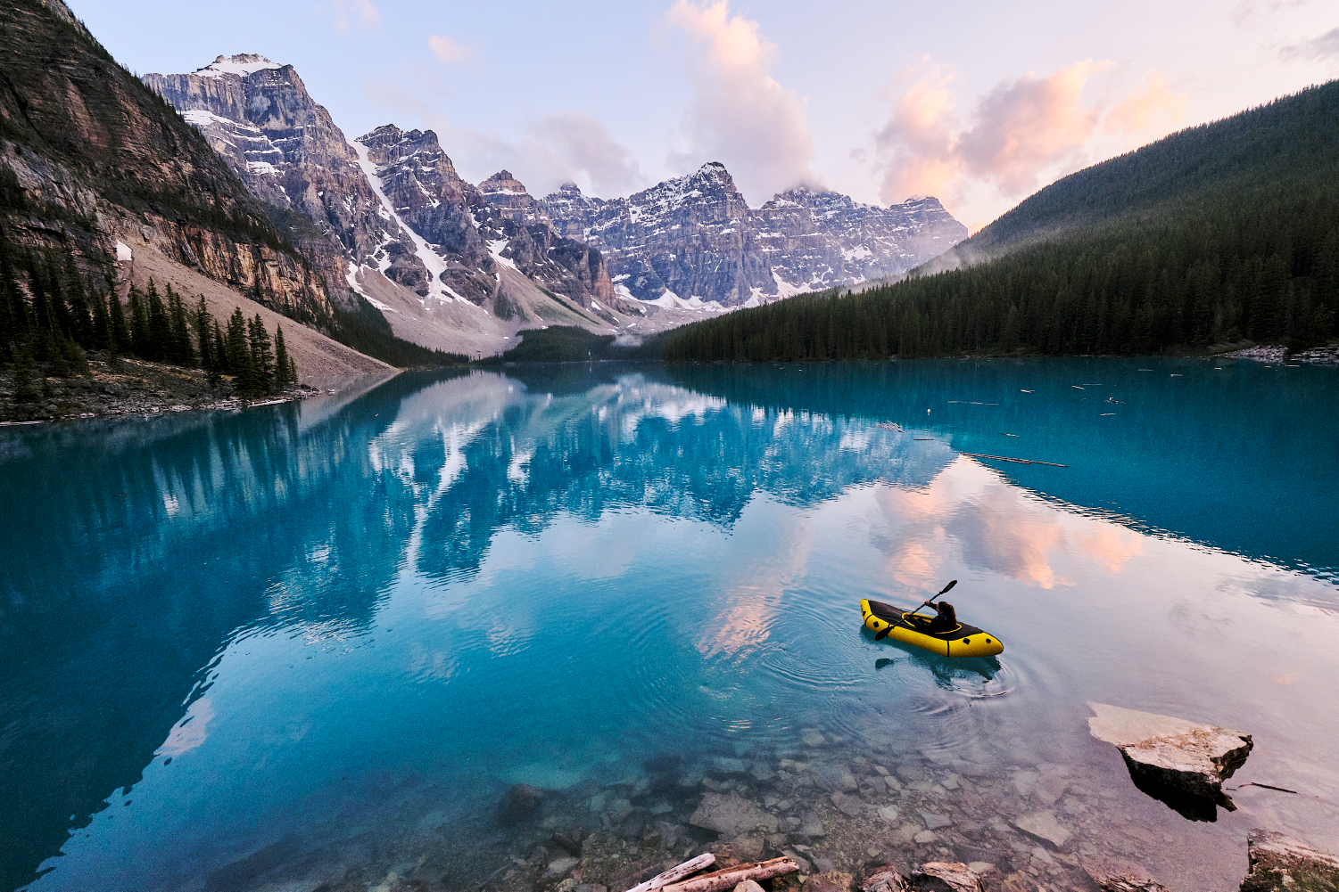 students at a table with laptops and books