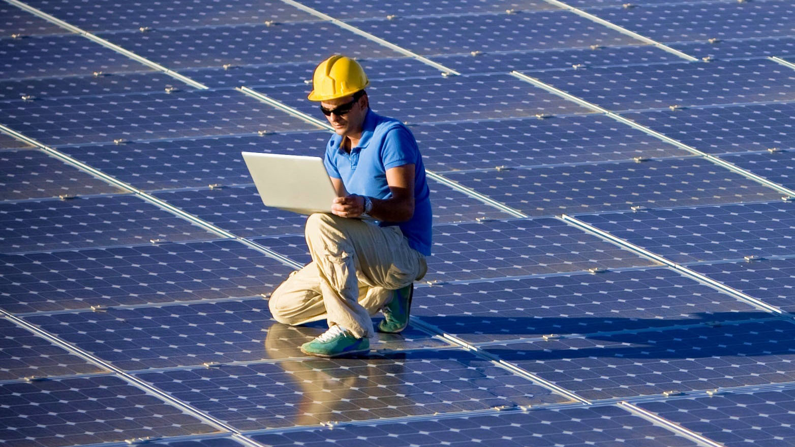 technician assessing solar panels