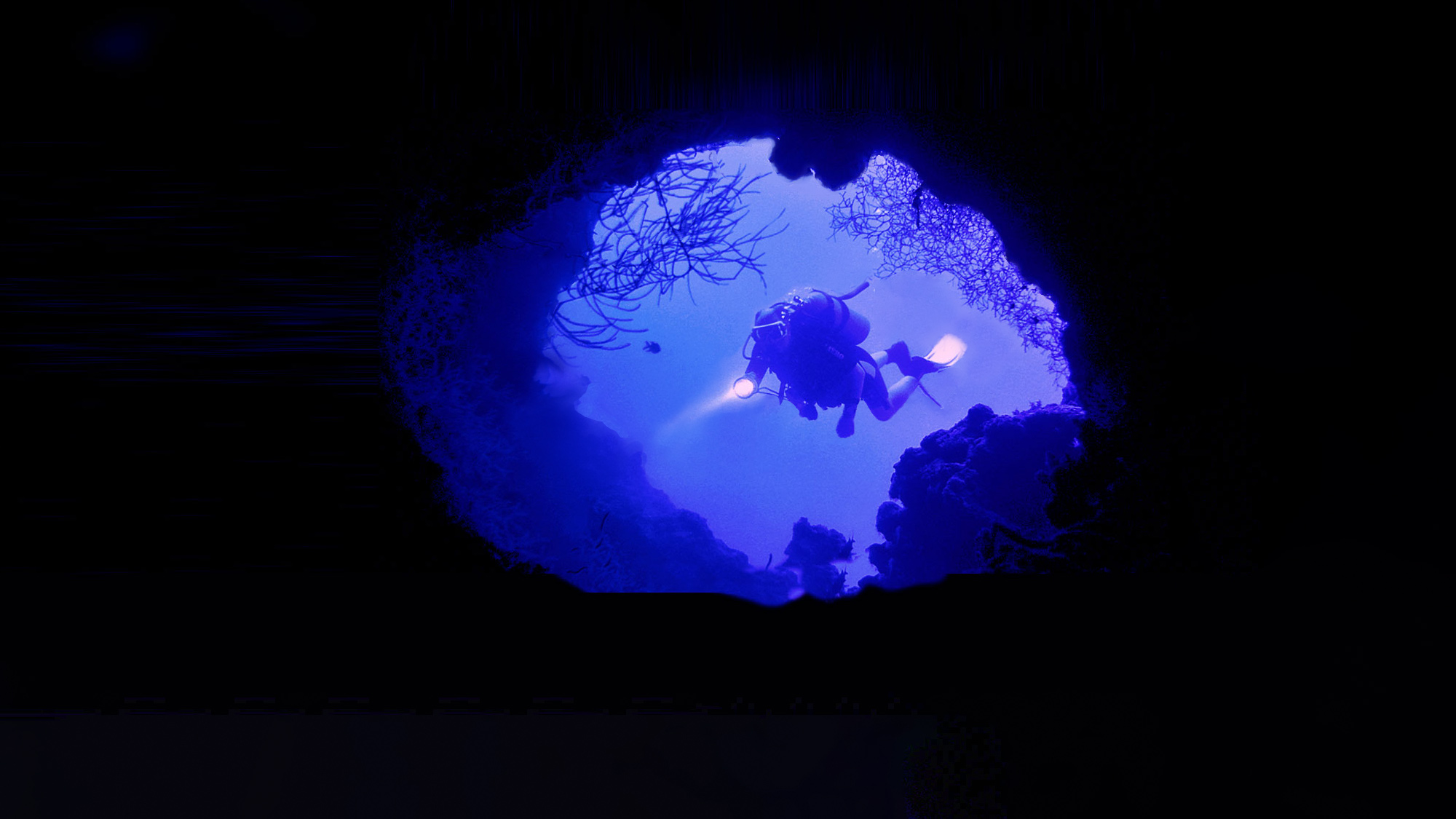 scuba diver exploring a cave